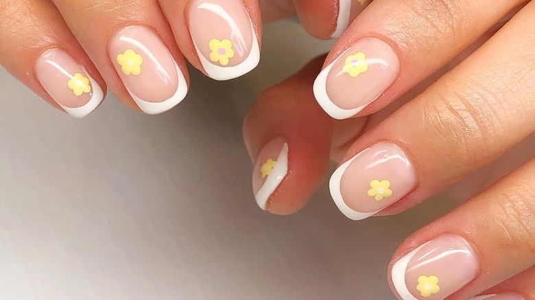 Floral art on a French manicure